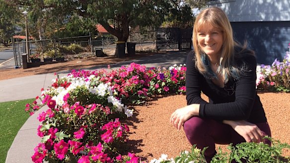Genoveva Fletcher's home in Torrens is next to, and across the road, from former Mr Fluffy blocks. She remains positive about the street's future.