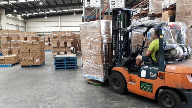 Boxes full of new plastic bottles for hand sanitiser manufactured by Pro-Pac Packaging in Melbourne.
