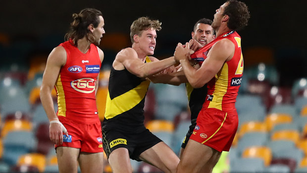 Richmond's Tom Lynch scuffles with Jarrod Witts of the Suns.