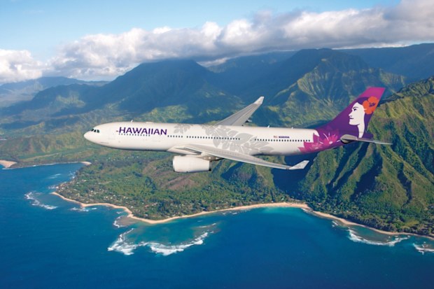 Hawaiian Airlines plane flying over island