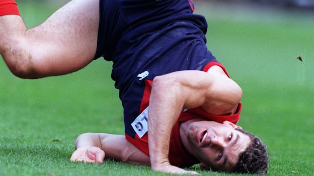 Melbourne’s Shaun Smith, one of the ex-players threatening to sue, hits the ground after attempting a mark in 1998.