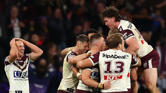Manly players celebrate after beating Melbourne.