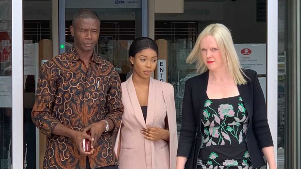 Haja Umu Timbo (centre) and her lawyer (right) outside court.
