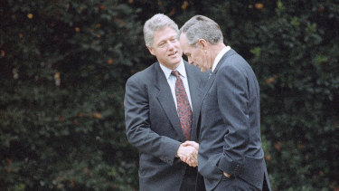 George H. W. Bush shakes hands with president-elect Bill Clinton after an Oval Office meeting in 1992. 