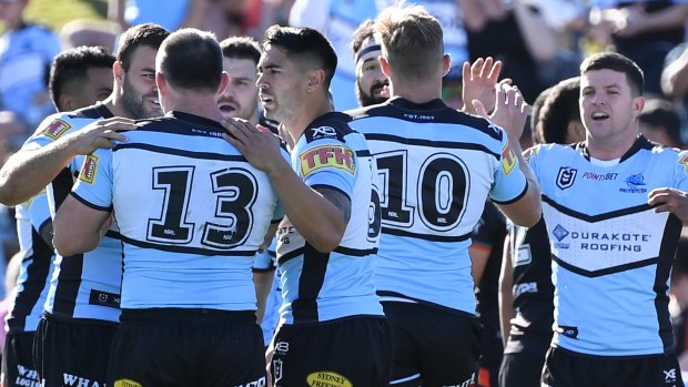 Landslide: The Sharks celebrate another try during their demolition job on the Warriors.