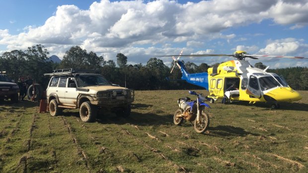 The RACQ LifeFlight helicopter lands in an open paddock on Sunday afternoon to transport an injured rider.