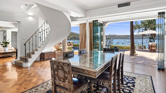 Interiors include parquetry floors, a sculptural staircase, gas kitchen, high ceilings and a neutral palette. 
