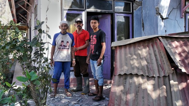From left: Kurniadi, Hasbi Haer and Ahmad Munadi outside their damaged house in Sembalun Bumbung.