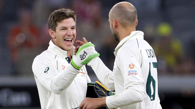 Over and out: Tim Paine and Nathan Lyon celebrate victory on night four, after the Australian spinner claimed the final New Zealand wicket to complete the win.