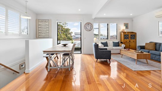 The auction of the three-bedroom home drew a large crowd of onlookers on Saturday morning.