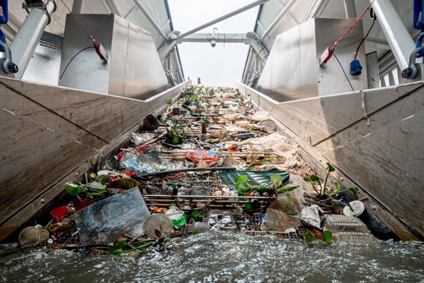 The Ocean Cleanup’s “Interceptor” vessel trawls a river in Malaysia for plastic before it hits the ocean.