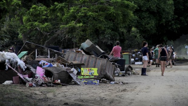 Residents start the clean up on Brisbane Terrace, Goodna, after floodwaters of the Bremer River devastated homes and businesses.