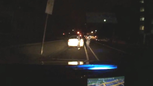 An image from dashcam footage showing Senior Constable Timothy Baker and Vlado Micetic on the night of the shooting.