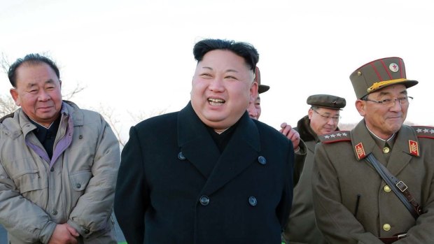 Kim Jong-un, centre, smiles during a missile launch in March.