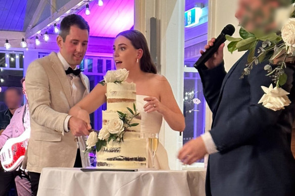 Mitchell Gaffney and Maddy Edsell cutting their wedding cake.