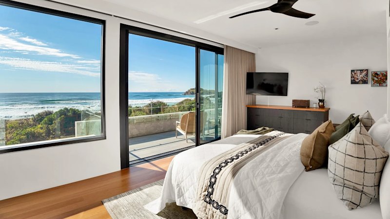 This beachfront stunner boasts views of the Pacific Ocean through floor-to-ceiling windows