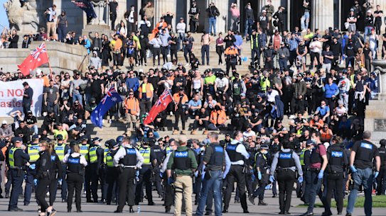 Protesters face-off with police on the steps of the Shrine of Remembrance.