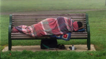 A homeless person in a city park.