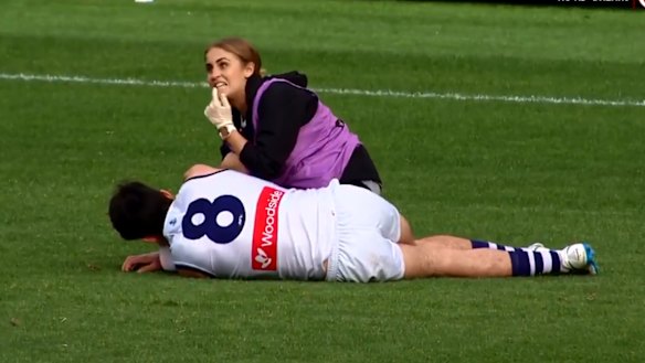 Andrew Brayshaw lies on the ground after the hit from Andrew Gaff.