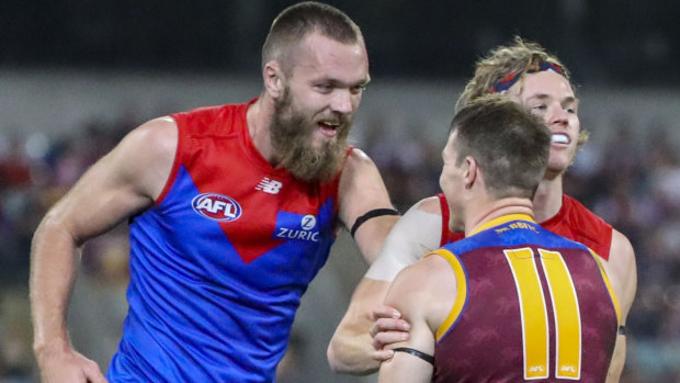 Tempers flare: Demons Max Gawn and Jayden Hunt exchange words with Lion Lincoln McCarthy.
