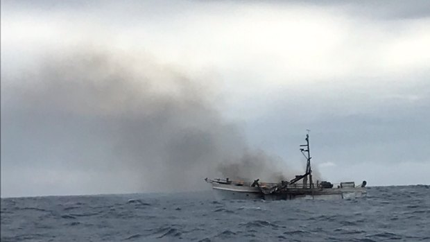 The smouldering wreckage of the charter boat off the Gladstone coast.