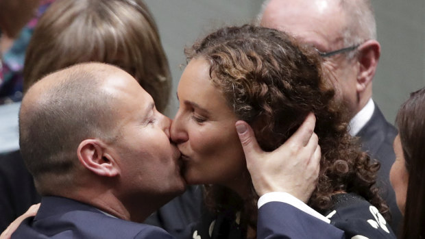 Treasurer Josh Frydenberg is congratulated by wife Amie after delivering the budget speech on Tuesday.