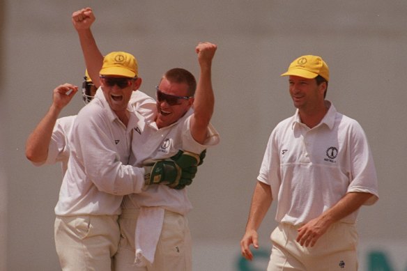 Australia’s Brad Young (centre) celebrates with Adam Gilchrist and Steve Waugh after taking a hat-trick in the semi-final at the 1998 Commonwealth Games.