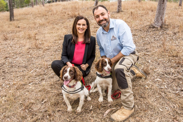 Queensland Urban Utilities spokeswoman Michelle Cull with dog handler Dennis Gannaway and the star dog duo, Halo and Danny. 