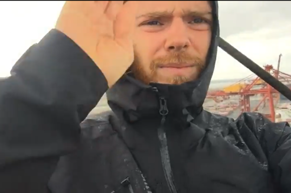 Blockade Australia protester, identified by the activist group as Max, has scaled a 40-metre crane to protest against climate inaction.