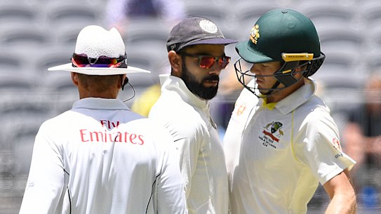 Up close and personal: Virat Kohli and Tim Paine exchange words in the second Test.