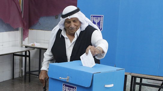 Israeli bedouin arabs cast their votes in a polling station in the city of Rahat, Israel, on Tuesday.