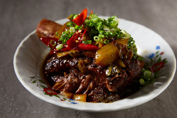 Caramelised beef short rib with pickled mustard greens, chilli and spring onions.