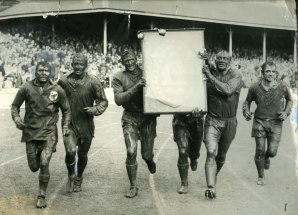 Captain Norm Provan and second-rower Kevin Ryan carry the J.J Giltinan Shield during St George's victory lap at the SCG in 1963.
