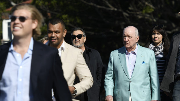 Alan Jones boarding a yacht at Rose Bay Wharf with Wallaby Kurtley Beale ahead of him on Friday.