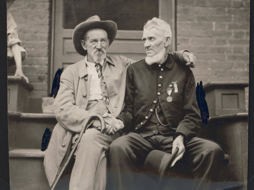 Confederate veteran and Union veteran, clasping hands at a 1913 Gettysburg reunion. 