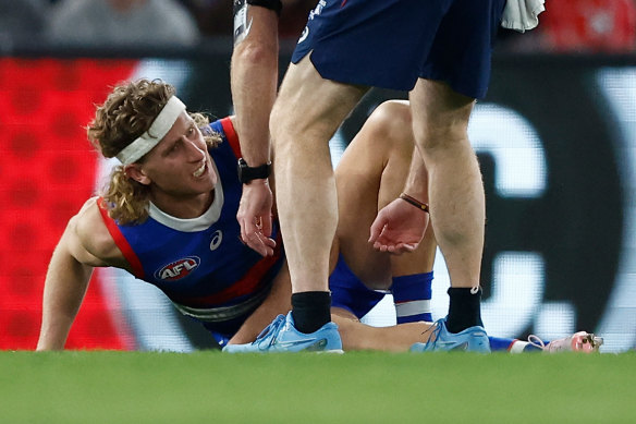 Aaron Naughton is attended by club staff after appearing to injure his knee.