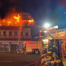 80 people escape uninjured as historic Queensland backpackers' hostel burns