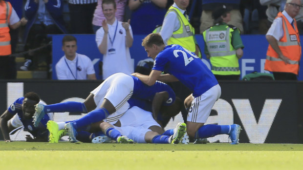 Upset: Leicester's James Maddison is buried by teammates as they celebrate his winning goal.