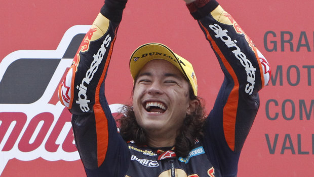 Moto3 rider Can Oncu, who is 15 years old, celebrates his historic victory in Valencia.