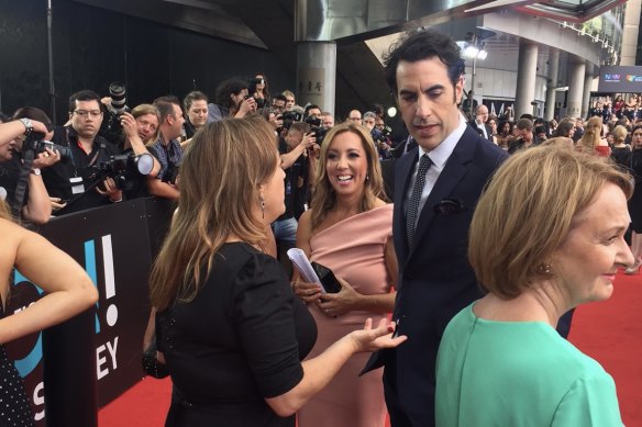 Niki White works the carpet with Sacha Baron Cohen.