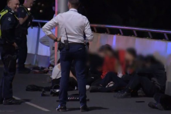 Police question youths near Flinders Street on Tuesday night.