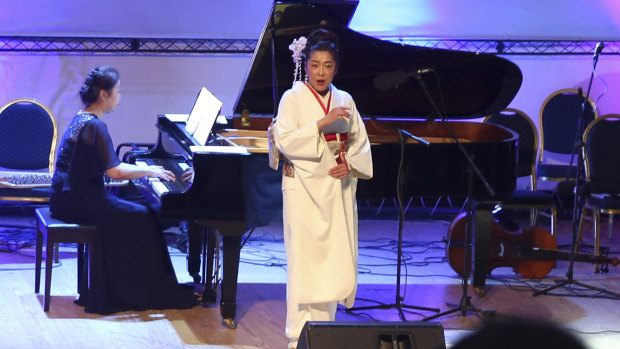 Japanese pianist Kaoru Imahigashi plays the piano for opera singer Fujiko Hirai during a concert to mark the debut of Gaza's only grand piano.