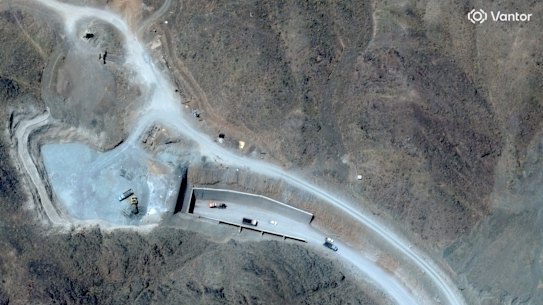 A satellite image shows vehicles at the western entrance to the Pickaxe Mountain secret complex.