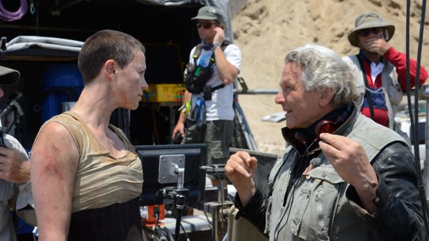 George Miller directs Charlize Theron on the set of Mad Max: Fury Road.