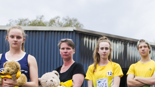 Woden athletics club users Caitlin Hanna, Woden Thunder Little Athletics club Secretary Mel Harding, Grace Brennan and Erek Lukowski are disappointed to see a Shed containing sports equipment at the Woden Athletics Park destroyed due to arson. 