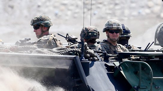 Amphibious Assault Vehicles, AAVs, carry American and Philippine troops in joint exercises in April.