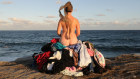 For her later work, nest, Katthy Caveliere sat on a bed of her late mother's clothes looking out to sea. 