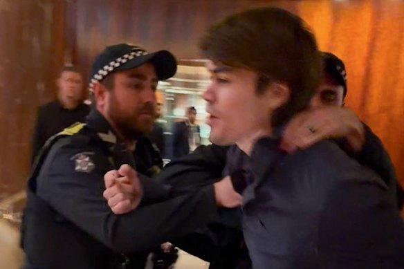 Screenshot of neo-Nazi associate Hugo Lennon being thrown out by police overnight from the Melbourne hotel where Indian Prime Minister Narendra Modi was staying.
