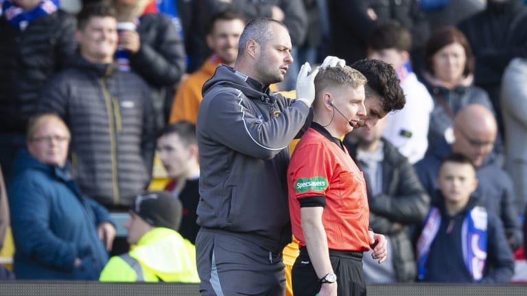 Unacceptable: Assistant referee Calum Spence receiving treatment.