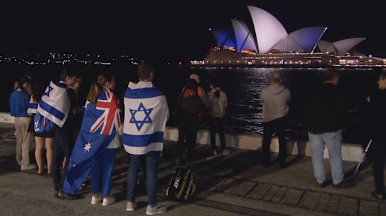 Warned off by police from attending the Sydney Opera House, supporters of Israel watched from afar on Monday night as it was lit up in blue and white. Pro-Palestinian protesters, meanwhile, filled the Opera House forecourt.